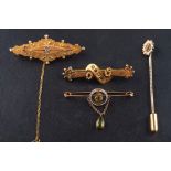 Three brooches and a tiepin, including a 9ct gold brooch set with a rose-cut diamond, 0.
