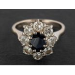 A sapphire and round, brilliant-cut diamond cluster ring, estimated sapphire weight ca. 0.