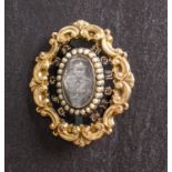 A 19th century black enamel and seed pearl mourning brooch/ pendant, with photograph,