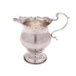 A George V silver pedestal cream jug, maker Wilson & Gill, Birmingham,