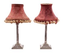 A pair of silver plated table lamps with foliate capital and cluster column on a weighted,