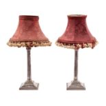 A pair of silver plated table lamps with foliate capital and cluster column on a weighted,