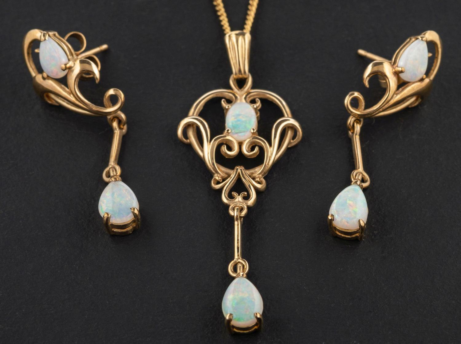 A 9ct gold openwork opal pendant and pair of earrings, the earrings with post fittings,