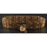 A 9ct gold gate-link bracelet with heart-shaped clasp, with hallmarks for London, 1986,