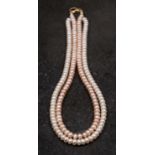 A two-row cultured pearl necklace, the cultured pearls of button form,