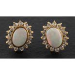 A pair of cabochon-cut opal and CZ cluster ear studs, total estimated opal weight ca. 1.