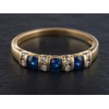An 18ct gold, sapphire and round, brilliant-cut diamond, half-eternity ring,