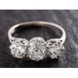A cushion-cut diamond, three-stone ring, total estimated diamond weight ca. 2.