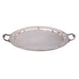 A large silver plated serving tray of oval outline with lobed border and foliate decorated loop