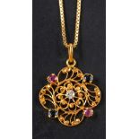 A quatrefoil, openwork ruby, sapphire and white paste pendant, stamped '875', length ca. 3.