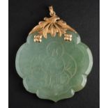 An engraved jade pendant, depicting 'Hotei Budai' to front with four characters to verso,