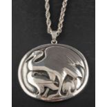 George Jensen (1866-1935) for Georg Jensen, a silver pendant depicting a crane and a raven,