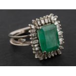 An emerald-cut emerald and baguette-cut diamond cluster ring, estimated emerald weight ca. 4.