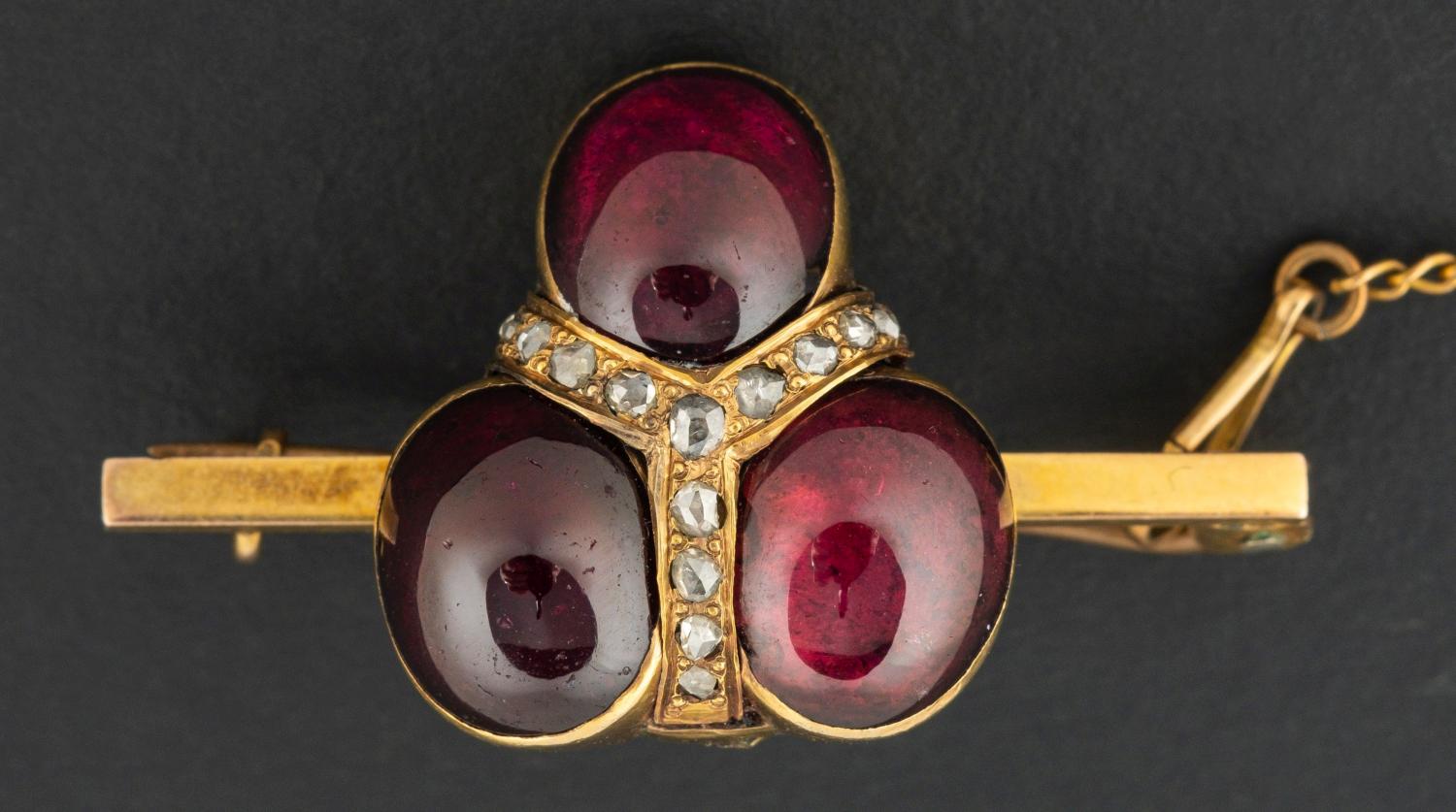 A 19th century, tripartite, cabochon-cut garnet and rose-cut diamond brooch, stamped 9ct,