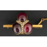 A 19th century, tripartite, cabochon-cut garnet and rose-cut diamond brooch, stamped 9ct,