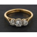 A round, brilliant-cut diamond three-stone ring, total estimated diamond weight ca. 0.