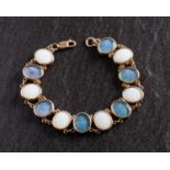 A 9ct gold, oval, cabochon-cut white opal and black opal triplet bracelet,