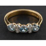 An 18ct gold, oval, mixed-cut aquamarine and round, brilliant-cut diamond ring,