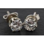 A pair of round, brilliant-cut diamond ear studs, total estimated diamond weight ca.