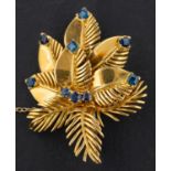 An 18ct gold, round, mixed and square step-cut sapphire floral brooch, with hallmarks for London,