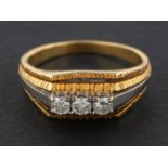 A round, brilliant-cut diamond, three-stone ring, total diamond weight 0.