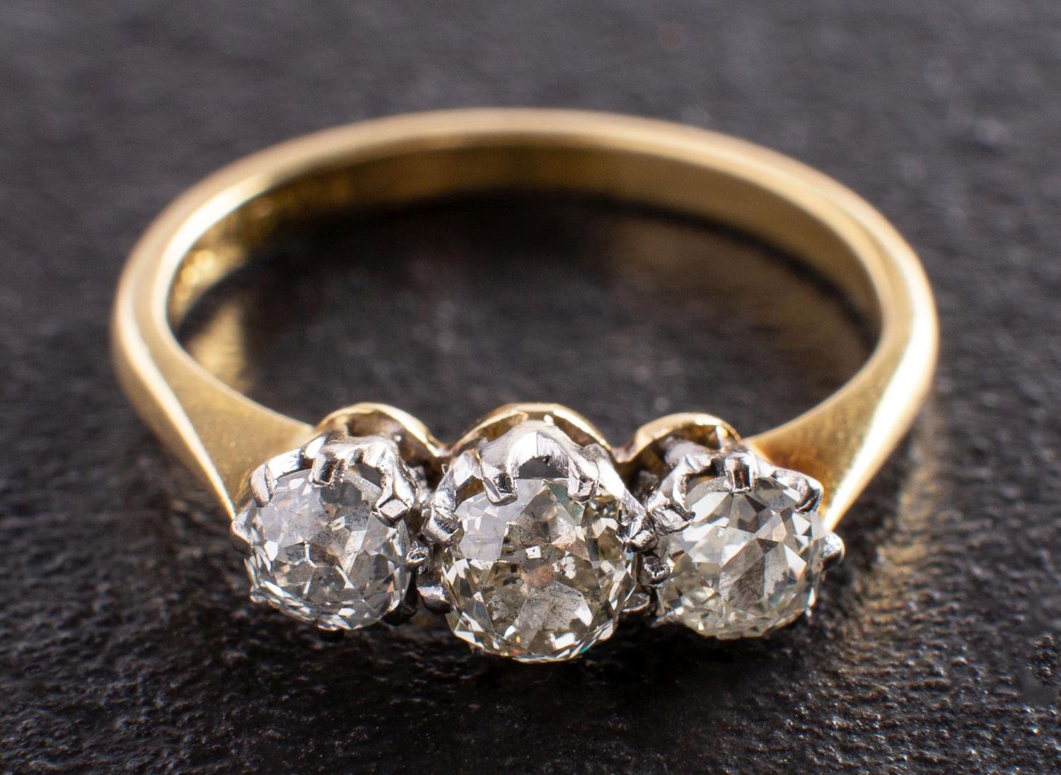 A cushion-cut diamond, three-stone ring, total estimated diamond weight ca. 1.
