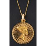 A medallion pendant, depicting Nefertiti's profile in relief, stamped '750',