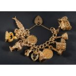 A 9ct gold, curb-link charm bracelet with heart-shaped clasp, including a sovereign gold coin,