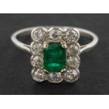 An emerald-cut emerald and old-cut diamond cluster ring, estimated emerald weight ca. 0.