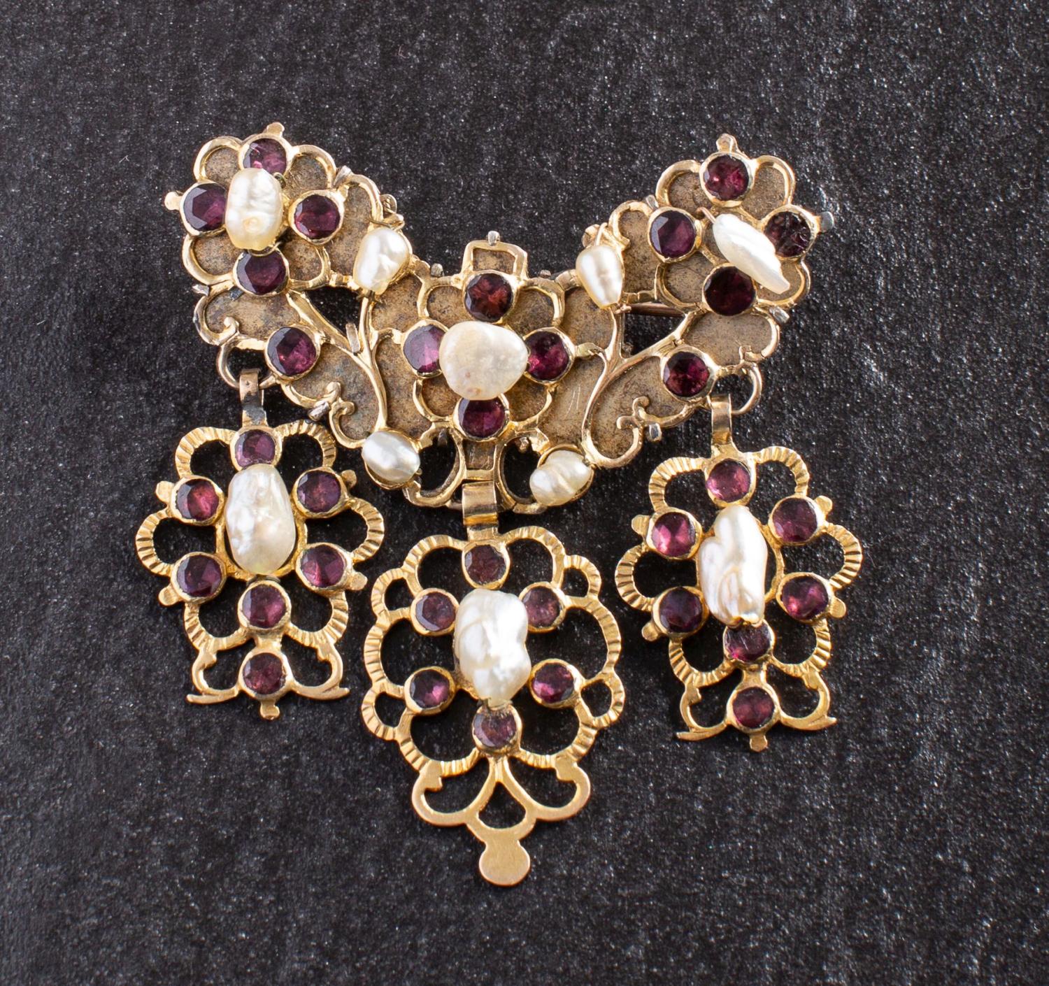 A 19th century, flat-cut, foil backed garnet and baroque-shaped pearl stomacher brooch/ pendant,