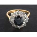 An 18ct gold, sapphire and round, brilliant-cut diamond cluster ring,: estimated sapphire weight ca.
