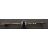 An oval, mixed-cut synthetic sapphire bar brooch, stamped '15CT', length ca. 5.
