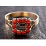 An early 19th century sentimental ring, the hairwork centrepiece with beaded coral surround,