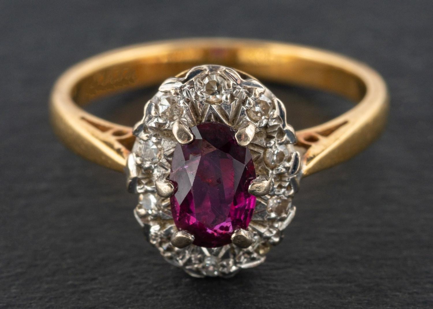 An oval, mixed-cut ruby and single-cut diamond cluster ring, estimated ruby weight ca. 0.