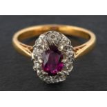 An oval, mixed-cut ruby and single-cut diamond cluster ring, estimated ruby weight ca. 0.