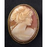 A shell cameo brooch, depicting a lady in profile, to rope twist surround, length ca. 4.
