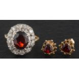 A garnet, single and round, brilliant-cut diamond cluster ring, total estimated diamond weight ca.