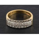 An 18ct gold, two-row, round, brilliant-cut diamond, half-eternity ring,