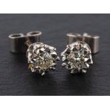 A pair of round, brilliant-cut diamond ear studs, estimated total diamond weight ca. 0.