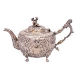 A chinoiserie design silver teapot, unmarked, bears crest and armorial, of circular outline,