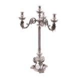 An Edwardian silver plated three branch candelabrum with urn-shaped sconces on winged griffin and