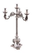 An Edwardian silver plated three branch candelabrum with urn-shaped sconces on winged griffin and