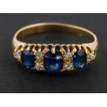 A cushion-cut sapphire, three-stone ring, with single-cut diamond spacers,