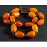 A two-strand, amber bead bracelet, diameter of beads ca. 9.5-12.2mms, total length ca. 19.