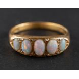 A cabochon-cut opal, half eternity ring with rose-cut diamond spacers, stamped '18CT',