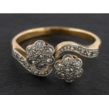 A single-cut diamond, double-flowerhead ring, of cross-over design,