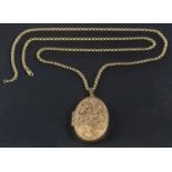 A 9ct gold, oval locket pendant with floral decoration, together with a belcher-link chain,