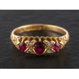 An Edwardian, 18ct gold, mixed-cut ruby three-stone ring, with rose-cut diamond spacers, 0.
