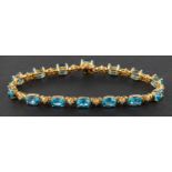 An oval, mixed-cut, blue topaz and diamond bracelet, total estimated topaz weight ca. 12.