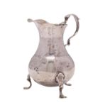 A George II silver cream jug, maker I.